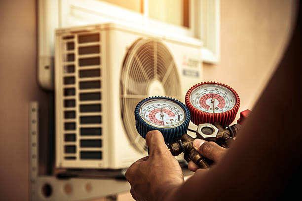Professional Air Conditioning Service technician working in Ellendale, ND